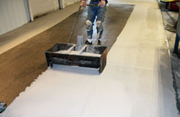 Workman installing an industrial floor.